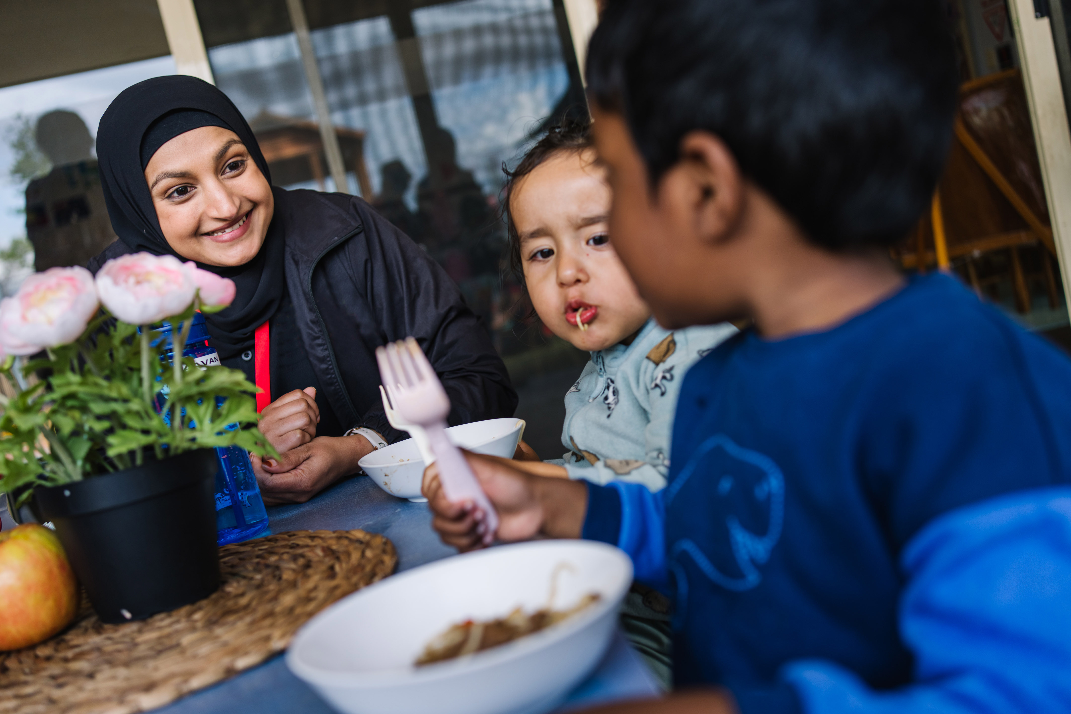 Educator with children at meal time